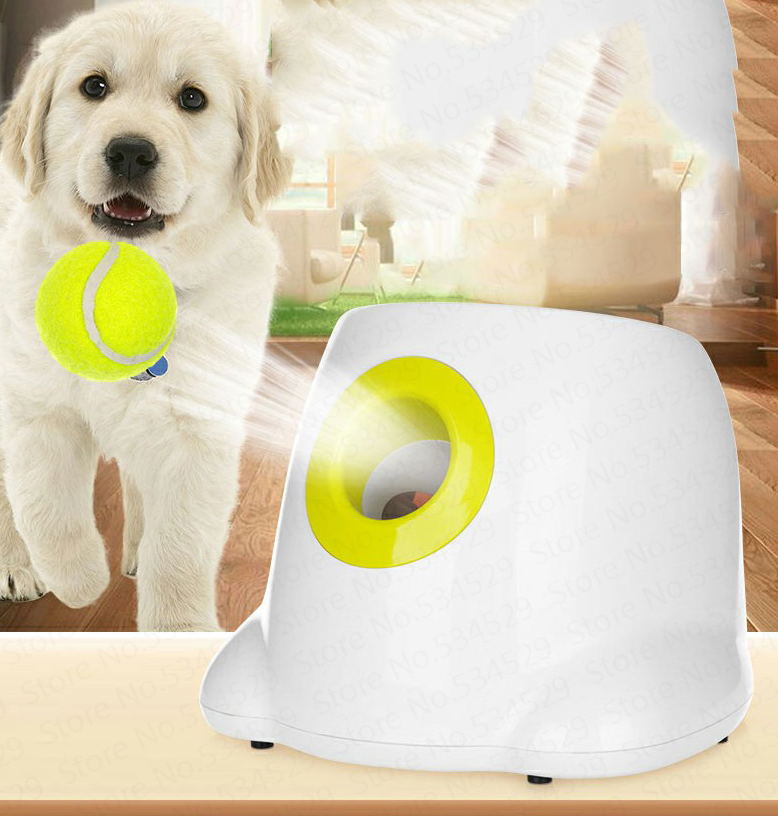 Ball launcher with yellow opening and green tennis ball, with a dog standing by it.