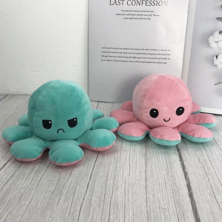 Plush octopus toys close-up in green and pink with small stitched smiles