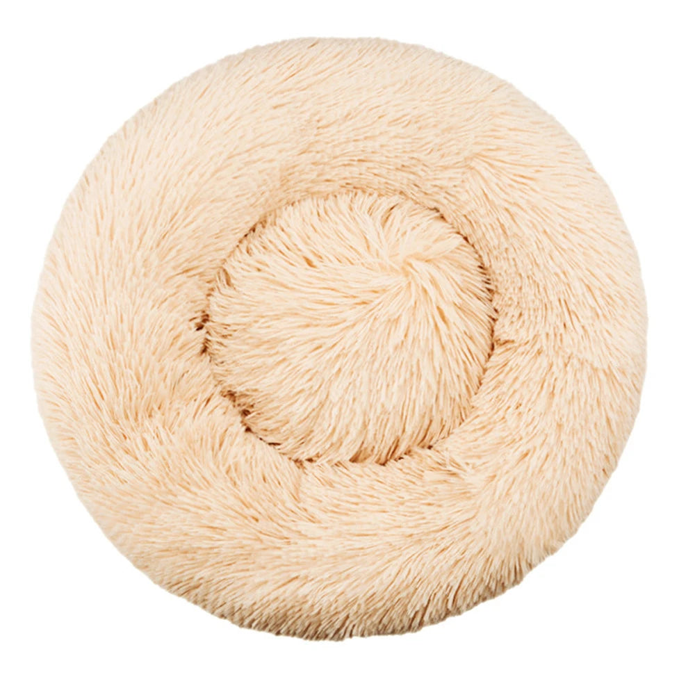 Top-down view of a round plush calming dog bed in tan faux fur