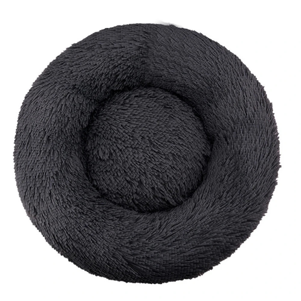 Top-down view of a round plush calming dog bed in charcoal black faux fur
