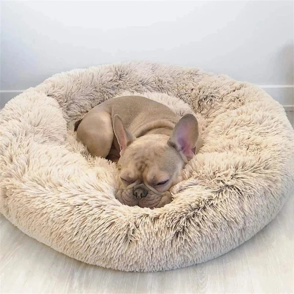 French Bulldog puppy sleeping in a round plush faux fur calming dog bed